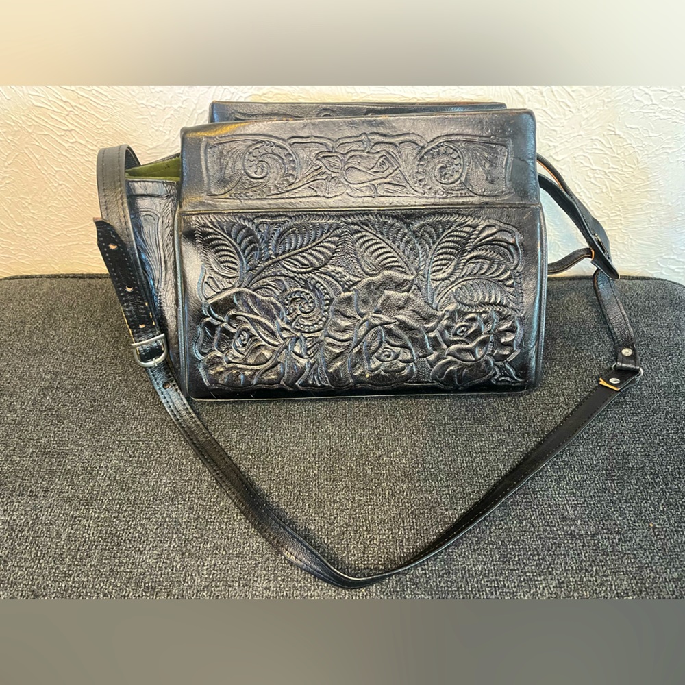 Vintage black leather purse with hand tooled floral pattern.